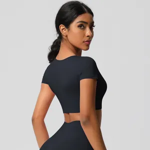 Side view of black short sleeve crop top and high-waisted leggings for yoga workout