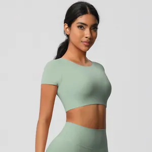 Detail of mint green yoga set featuring breathable short sleeve top and high waist leggings