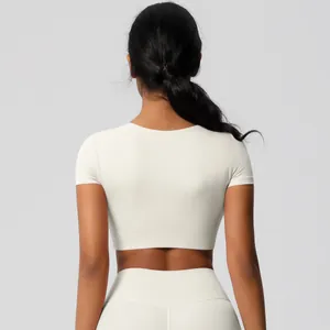 Rear view of a slim-fit ivory yoga set showing seamless fabric and athletic silhouette