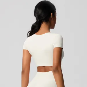 Rear view of a tight white crop top athletic shirt for women yoga and fitness