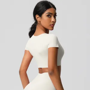 Detail of a tight-fit cream-colored crop top for yoga featuring premium high-stretch fabric
