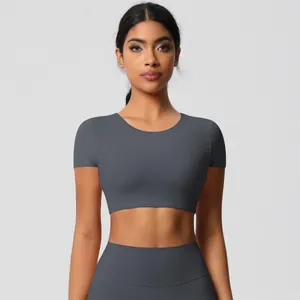 Detail of charcoal grey seamless yoga set with high-waist leggings and crop top shirt
