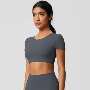 Detail of dark grey seamless yoga set featuring cropped short sleeve top and leggings