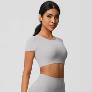 Side view of light gray seamless yoga set with cropped short sleeve top and leggings