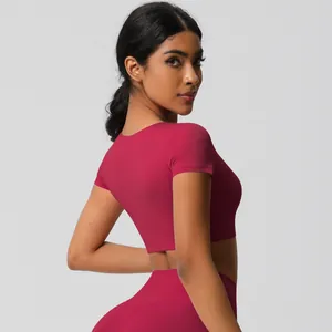 Detailed side view of fuchsia high-waisted leggings and cropped yoga top set