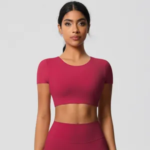 Front view of a magenta yoga set with short sleeve crop top and high-waist sports leggings