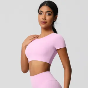 Detail of light pink yoga set featuring moisture-wicking fabric and high-waisted leggings