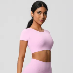Detail view of pink high-waist yoga set with short-sleeve top and seamless leggings
