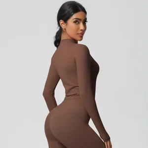 Detail of high-waist yoga leggings and zip-up long sleeve top in coffee brown