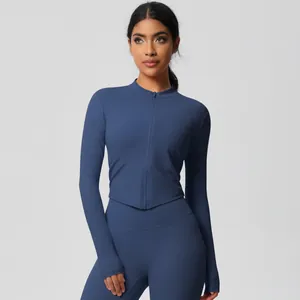 Detail of dark blue yoga jacket featuring a standing collar, full zipper, and thumbholes