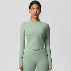 Detail of mint green yoga set featuring thumb holes and slim-fit V-hem zip jacket