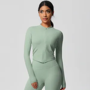 Detail of sage green yoga set with stand collar zipper and thumbhole cuffs