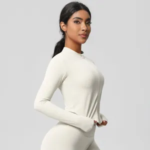 Detail of cream yoga set featuring full-zip jacket with functional thumbholes