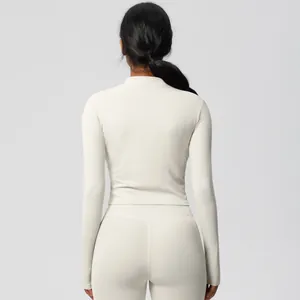 Rear view of slim fit cream yoga set showing high waist leggings and stand collar jacket