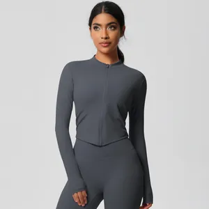 Close-up of seamless stitching and slim fit design on dark grey yoga jacket and leggings
