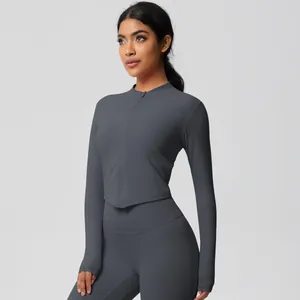 Close-up of charcoal gray yoga set showing thumb hole detail and slim-fit zipper jacket