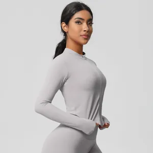 Detail view of grey long sleeve zip-up yoga set with thumbholes and matte fabric