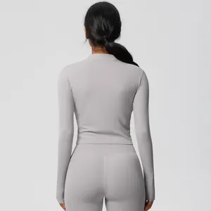 Rear view of a light gray long-sleeved tight yoga set and high-waisted leggings