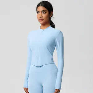 Detail of light blue tight fit yoga set featuring zip-up long sleeve top and leggings