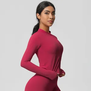 Detail of rose red yoga set featuring thumb holes and high-waist compression leggings