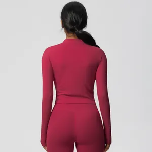 Back view of a slim fit deep red yoga set featuring long sleeves and high waist leggings