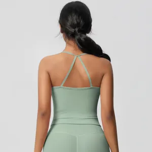 Back view of light green yoga set showing cross-strap sports bra and high-waist leggings