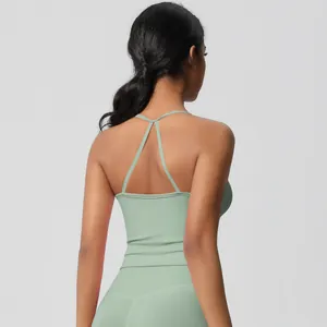 Detail of cross-back straps on a mint green yoga sports bra with soft matte fabric
