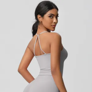 Light gray yoga set featuring cross-back thin straps and high-waist athletic leggings