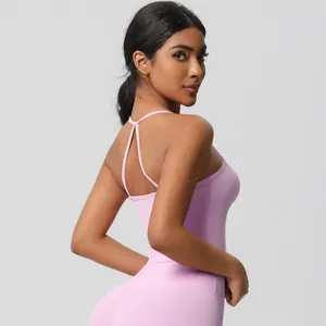 Detail of cross-back straps and moisture-wicking fabric on pink yoga top