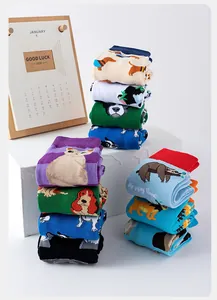 Macro detail of high cotton crew socks featuring cute cartoon animal designs and contrast toes