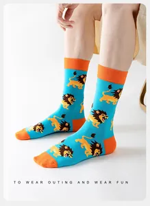 Close-up of blue and orange crew socks with cartoon lion pattern and cotton texture