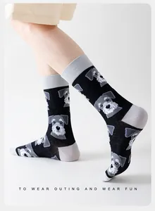 Detail of high cotton crew socks featuring grey Schnauzer dog pattern and fun text print