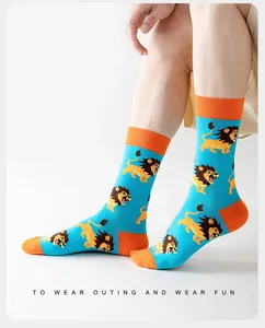 Detailed knit texture of lion pattern cotton crew socks with vibrant orange contrast cuffs