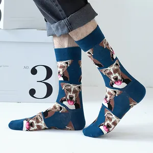 Detail of dark blue crew socks featuring cartoon dog print worn with black jeans