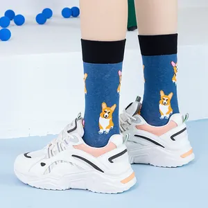 Detail of dark blue crew socks with Corgi pattern and white platform sneakers