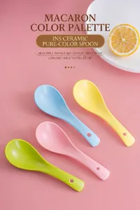 Close-up of matte pastel ceramic spoons with hanging holes and smooth glazed finish