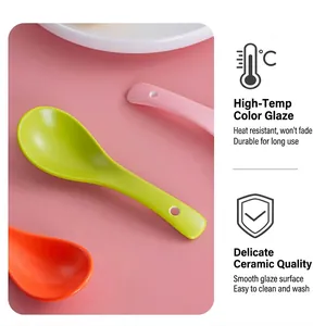Detail of colorful ceramic spoons with smooth glaze finish and hanging hole handles