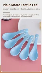 Detailed close-up of five matte ceramic spoons in light blue with hanging holes