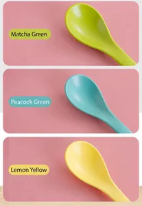 Ceramic spoons in Matcha Green, Peacock Green, and Lemon Yellow on a soft pink background