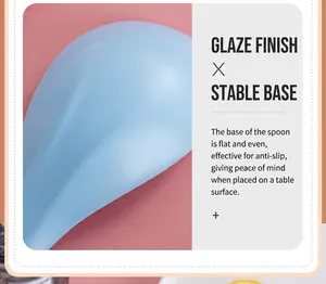 Close-up of light blue ceramic spoon with glazed finish and non-slip flat bottom design