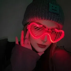 Detail of red heart-shaped LED shutter glasses with glowing frame for parties
