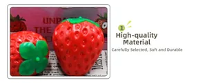 Macro detail of red strawberry squishy toy showing soft texture and realistic leaf design