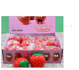 Set of 12 realistic strawberry squishy toys in a pink display box for stress relief