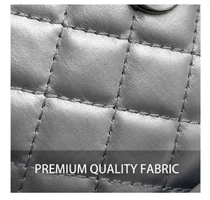 Close-up of gray quilted leather texture with high-quality stitching on backpack
