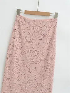 Detailed close-up of pink floral lace texture on elegant high-waisted pencil skirt