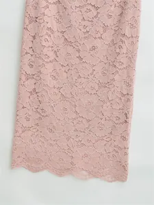 Close-up of soft pink floral lace fabric with delicate eyelash trim edge detail