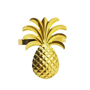 Golden pineapple napkin ring holder with detailed metallic texture on white background