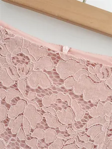 Close-up of floral lace texture and invisible zipper on pink high waist skirt