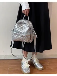 Chic silver quilted mini backpack with metallic finish and elegant bow decoration for women