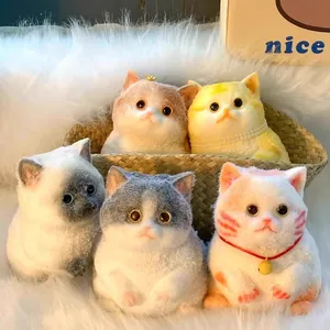 Close-up of five creative wool felt cat figurines with pearl necklaces and crowns